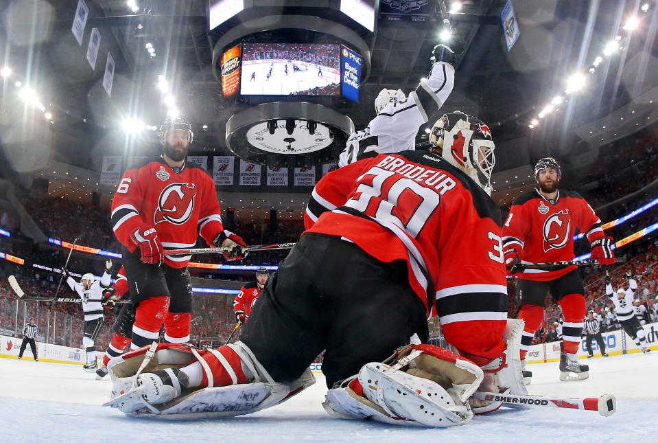 NEWARK, NJ - JUNE 02: Jeff Carter #77 of the Los Angeles Kings (not pictured) shoots the game winning goal in overtime passed Martin Brodeur #30 of the New Jersey Devils as Andy Greene #6, Dustin Penner #25 and Stephen Gionta #11 look on during Game Two of the 2012 NHL Stanley Cup Final at the Prudential Center on June 2, 2012 in Newark, New Jersey. (Photo by Bruce Bennett/Getty Images)