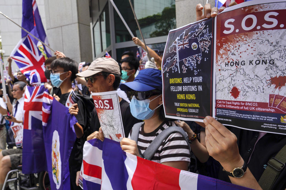 Protesters hold placards and wave British flags during a peaceful demonstration outside the British Consulate in Hong Kong, Sunday, Sept. 15, 2019. Hundreds of Hong Kong activists rallied outside the Consulate for a second time this month, bolstering calls for international support in their months-long protests for democratic reforms in the semi-autonomous Chinese territory. (AP Photo/Vincent Yu)
