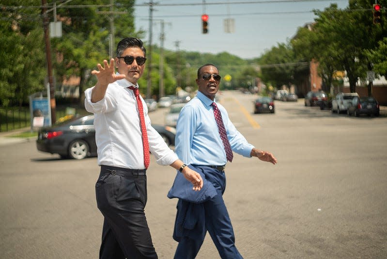 Cincinnati Mayor Aftab Pureval, left, walks through Cincinnati's West End neighborhood with Ohio Department of Transportation Director Jack Marchbanks on May 22.