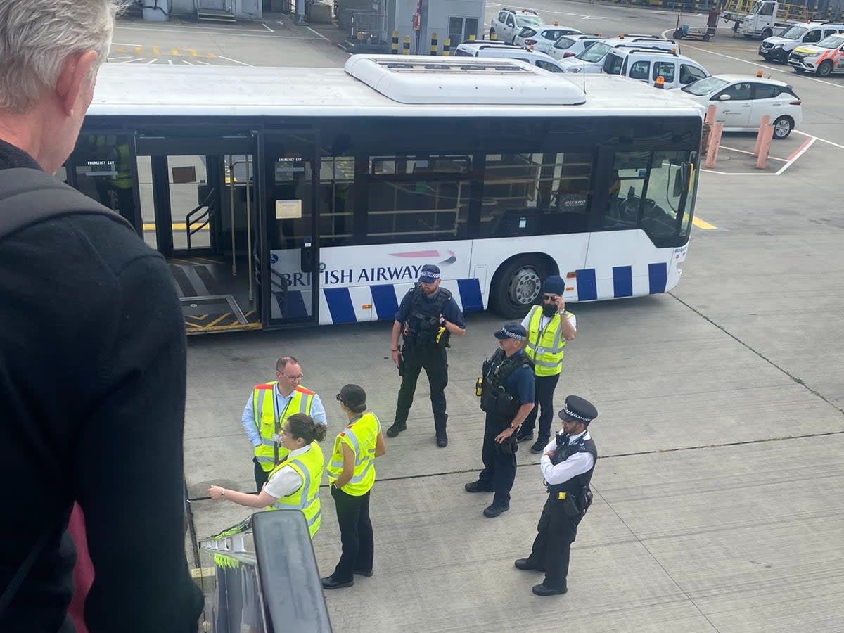 Wrong airport: British Airways staff and airport police at the foot of the stairs of a BA Airbus A321 diverted from Gatwick to Heathrow (Annemarie)