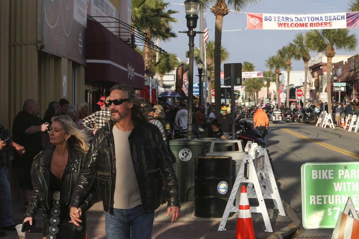 People walk down Main Street in Daytona, FL during the starting day of Bike Week on March 5, 2021. (Sam Thomas/Orlando Sentinel)