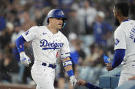 Los Angeles Dodgers' Kiké Hernández celebrates with teammates after hitting a solo home run against the Washington Nationals during the fifth inning of a baseball game Tuesday, April 16, 2024, in Los Angeles. (AP Photo/Marcio Jose Sanchez)