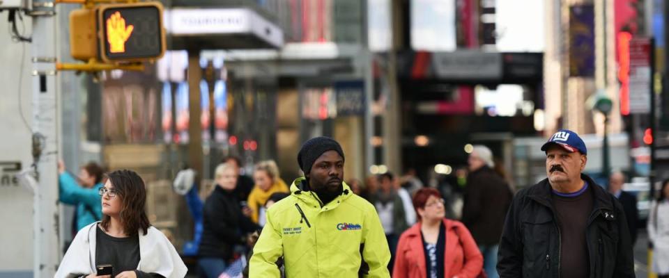 NEW YORK CITY, USA - NOV 11, 2015: People walk along a busy downtown Manhattan street. Manhattan is home to 1.6 million New Yorkers with a population density of 71,671 per sq mile.