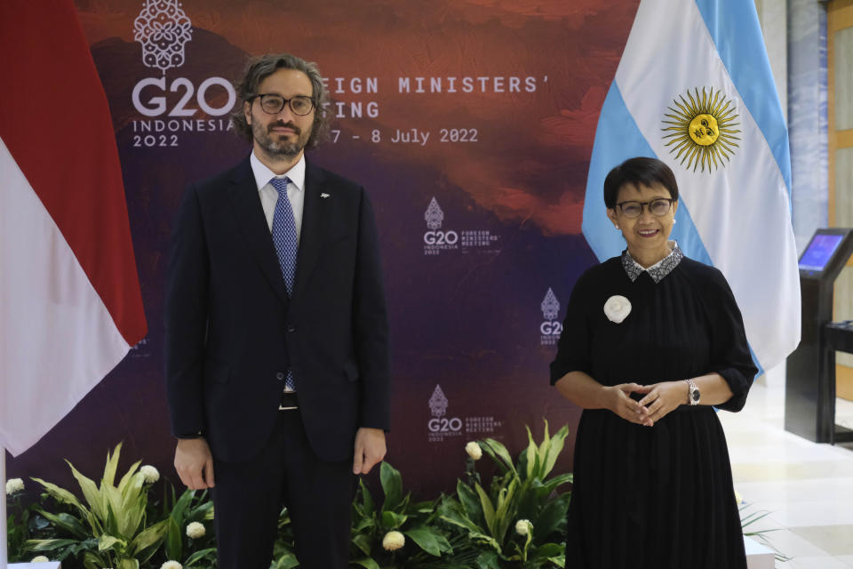 In this photo released by Indonesian Ministry of Foreign Affairs, Argentine Foreign Minister Santiago Cafiero, left, poses for photographers with his Indonesian counterpart Retno Marsudi during their bilateral meeting ahead of the G20 Foreign Ministers' Meeting in Nusa Dua, Bali, Indonesia, Wednesday, July 6, 2022. Foreign ministers from the Group of 20 leading rich and developing nations are gathering in Indonesia's resort island of Bali for talks bound to be dominated by the conflict in Ukraine despite an agenda focused on global cooperation and food and energy security. (Indonesian Ministry of Foreign Affairs via AP)