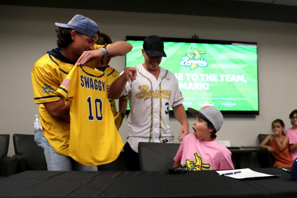 Noah Bridges shows Mark "Swaggy" Lane the new Savannah Bananas jersey that he will be wearing during the game at Historic Grayson Stadium. "Swaggy" received the jersey on Wednesday after signing his contract to play for the Bananas as a part of his wish with the Make a Wish Foundation.