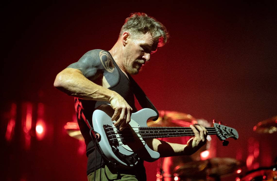 Tom Commerford attacks his bass as Rage Against the Machine plays Raleigh, N.C.’s PNC Arena.