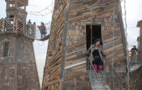 <p>Participants walk through an art installation as approximately 70,000 people from all over the world gather for the 30th annual Burning Man arts and music festival in the Black Rock Desert of Nevada, Aug. 30, 2016. (REUTERS/Jim Urquhart)</p>