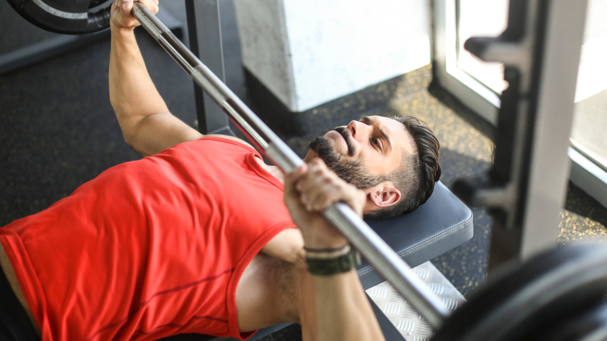  Man performing bench press. 