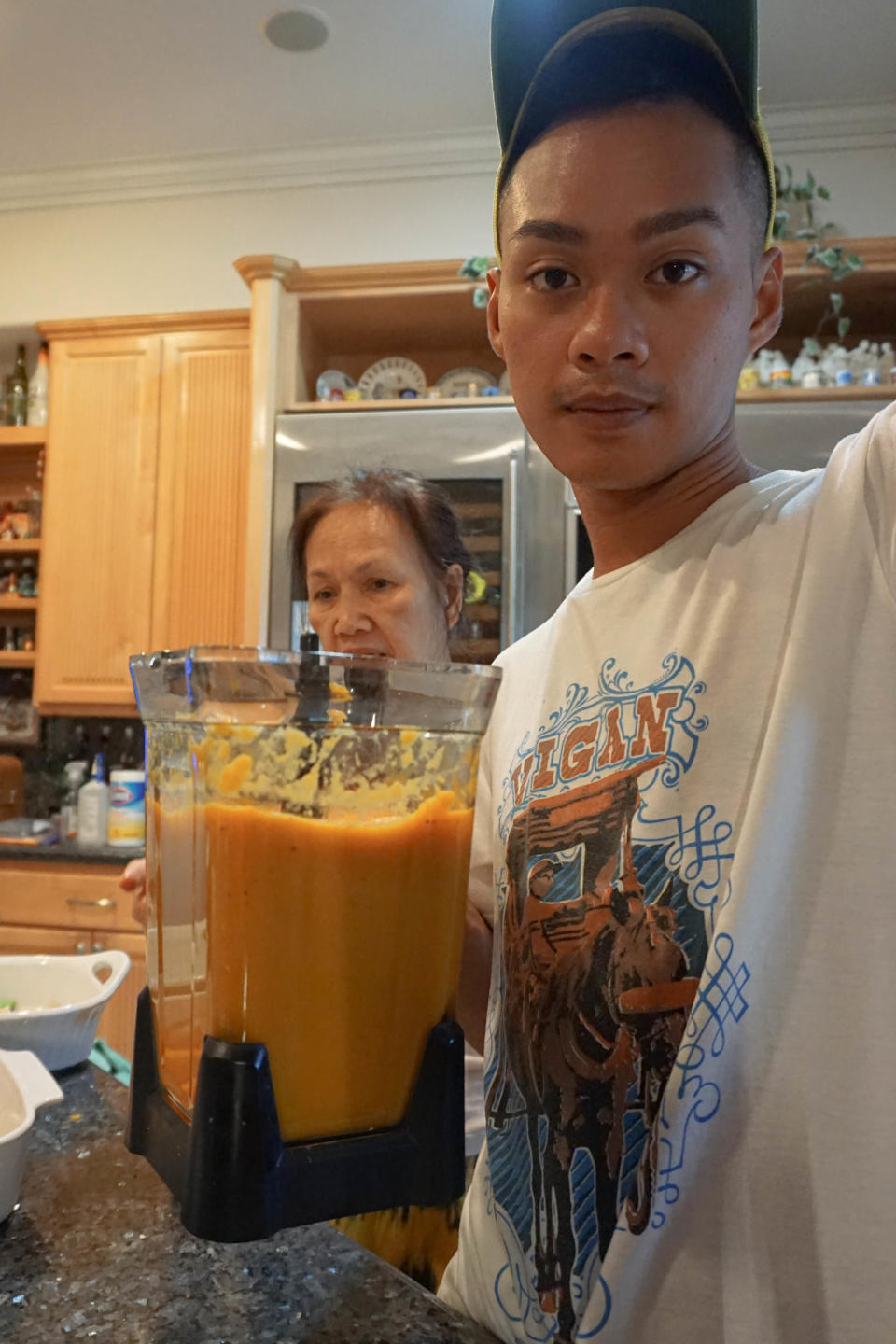 author holding a blender full of blended squash