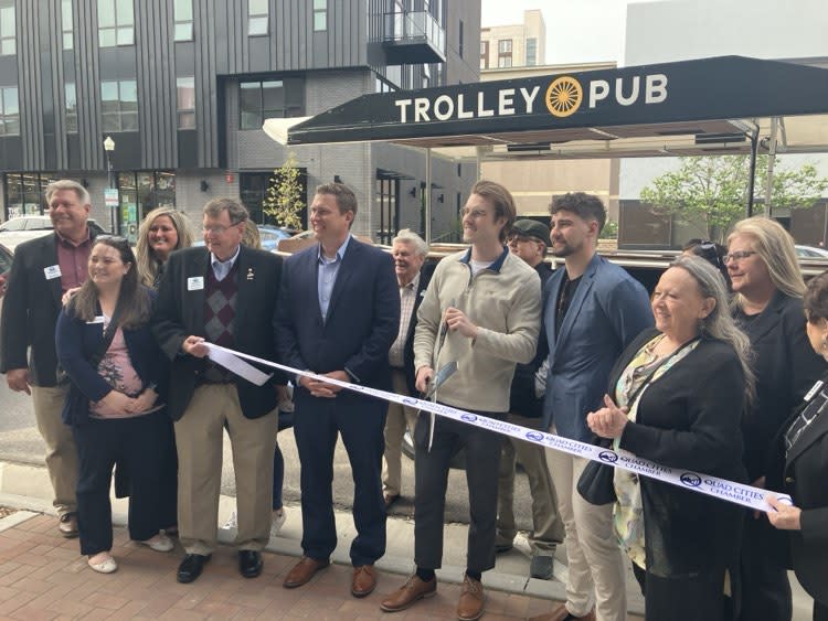 City of Davenport, QC Chamber and Visit Quad Cities leaders join Trolley Pub owners Will Rice and Sam Volkmer in a ribbon-cutting for the new service Monday, April 22, 2024 (photo by Jonathan Turner).