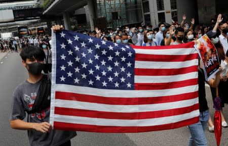 Anti-government office workers wearing masks attend a lunch time protest, after local media reported on an expected ban on face masks under emergency law, at Central, in Hong Kong