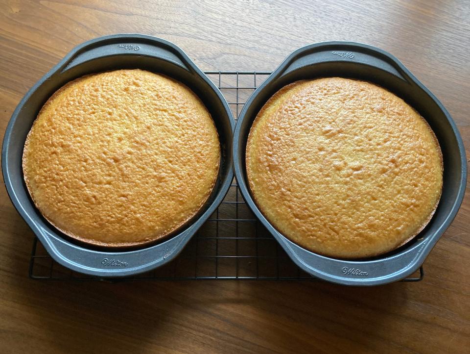 Betty Crocker cake mix in 9-inch rounds on a cooling rack on a wood table