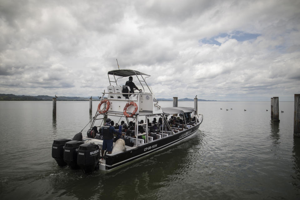 Haitian migrants ride a boat towards Capurgana near the border with Panama, in Necocli, Colombia, Wednesday, July 28, 2021. Thousands of migrants have been gathering in Necocli as they move north towards Panama on their way to the U.S. border. (AP Photo/Ivan Valencia)