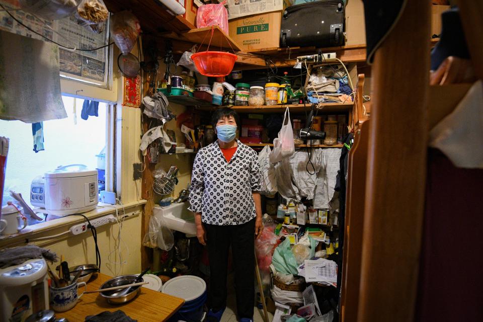 Mei Chan Lao poses for a portrait inside of her 10-by-10-foot room in San Francisco's Chinatown.