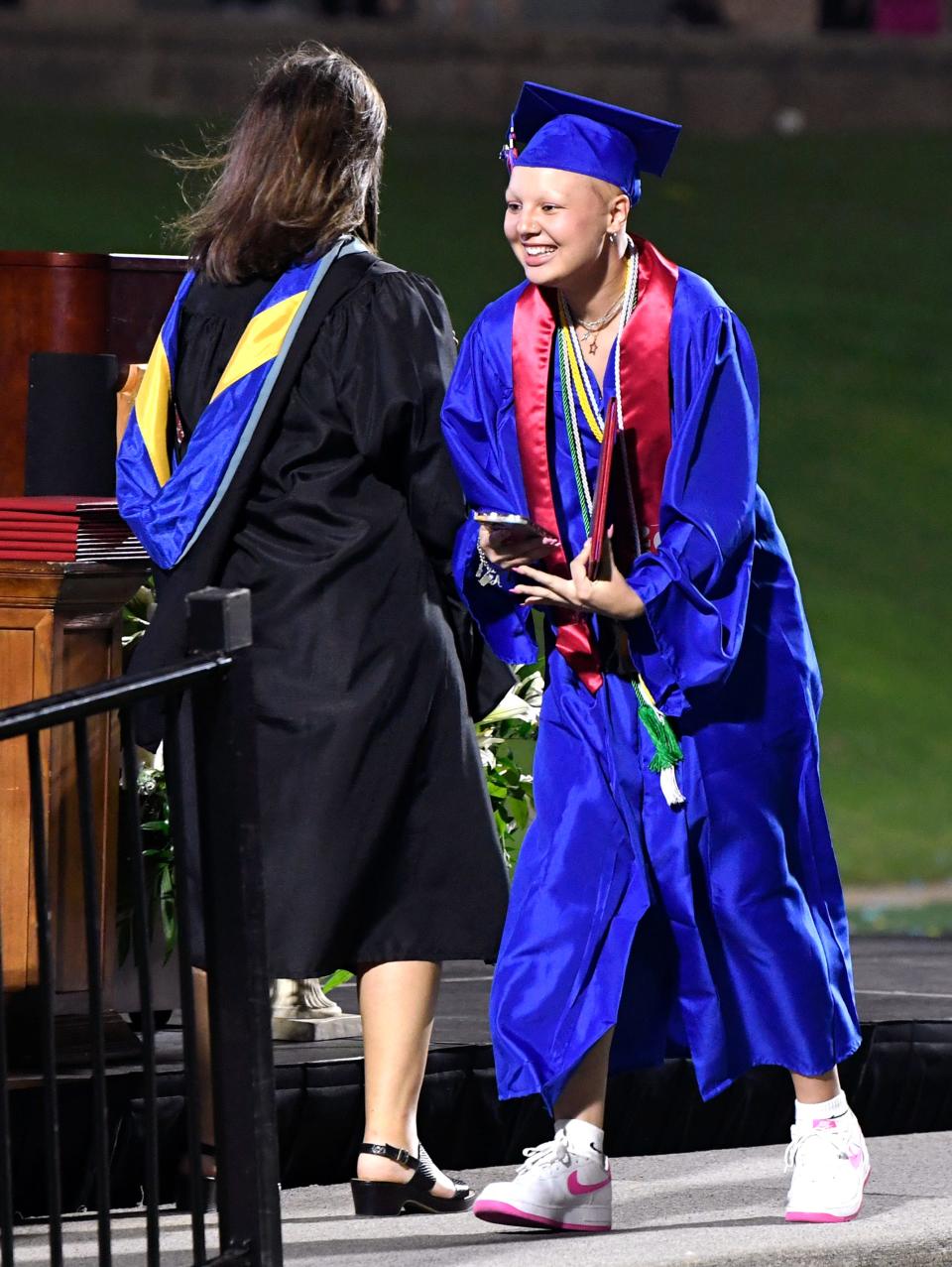 Abigail Pena-Perez receives her diploma from Cooper High School Principal Lindsey Williamson during Saturday's commencement ceremony at Shotwell Stadium.  Cooper graduated 401 seniors.