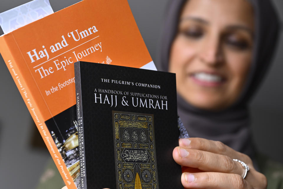 Muslim family member Saadiha Khaliq holds material which she read in preparing for her upcoming trip to hajj, pictured Wednesday, June. 7, 2023, in Murfreesboro, Tenn. The Khaliq family are planning to travel together to Mecca in Saudi Arabia for hajj, the pilgrimage which every adult Muslim who can afford it and is physically able, must make at least once in his or her lifetime. The hajj is the fifth of the fundamental Muslim practices and institutions known as the Five Pillars of Islam. (AP Photo/John Amis)