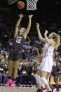 Oklahoma guard Gabby Gregory (12) scores past Baylor forward Lauren Cox (15) in the first half of an NCAA college basketball game Saturday, Feb. 22, 2020, in Waco, Texas. (AP Photo/Jerry Larson)