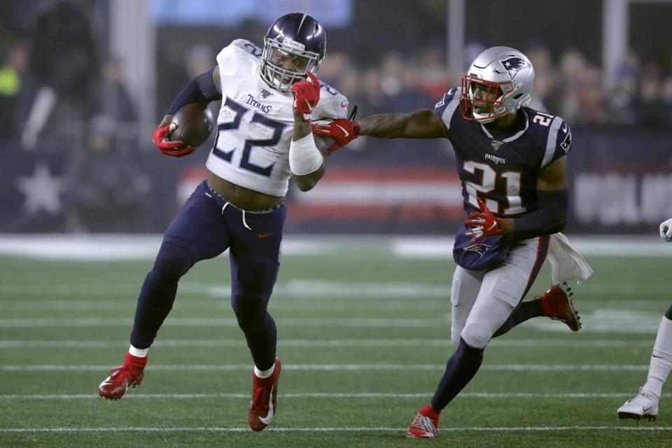 Tennessee Titans running back Derrick Henry runs from New England Patriots safety Duron Harmon. (AP Photo/Charles Krupa)