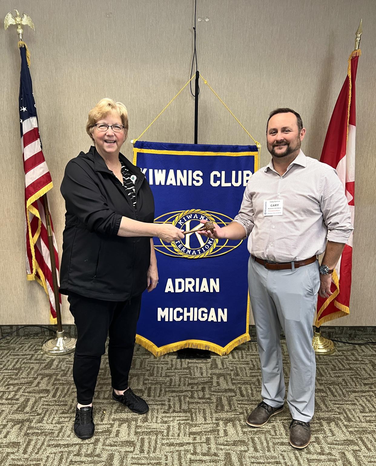 Pictured are Kiwanis Club of Adrian Past-President Lynne Punnett, left, and newly inducted President Cary Carrico, right, during the ceremonial “passing of the gavel," which signals the transfer of the presidency from the current, outgoing president to the new, incoming president for the next year.