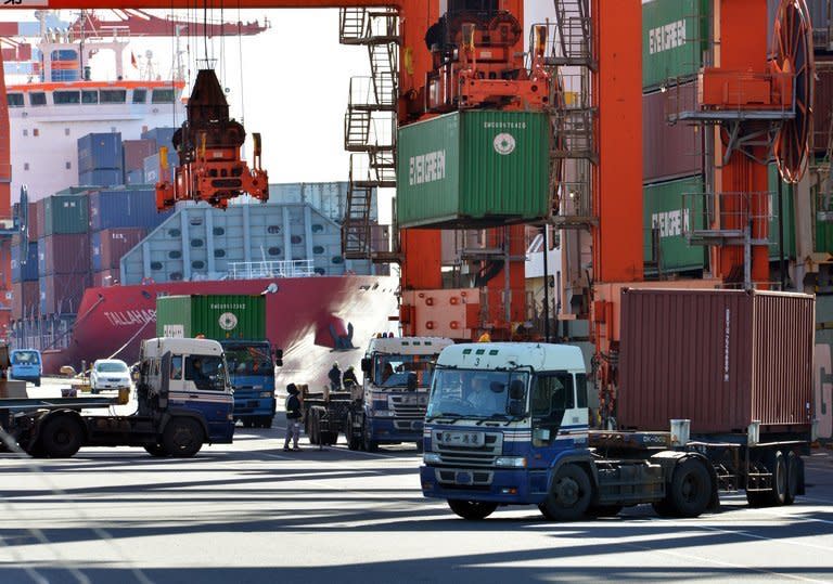 Containers are unloaded from freighters at Tokyo's port on January 11, 2013. Japan's hard-charging prime minister said he wanted in on talks to forge a huge trade pact, the latest bold move from a man who says he is determined to lick the frail economy into shape