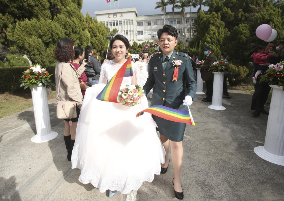 Lesbian couple Chen Ying-hsuan, right, and Li Li-chen attend a military mass weddings ceremony in Taoyuan city, northern Taiwan, Friday, Oct. 30, 2020. Two lesbian couples tied the knot in a mass ceremony held by Taiwan's military on Friday in a historic step for the island. Taiwan is the only place in Asia to have legalized gay marriage, passing legislation in this regard in May 2019. (AP Photo/Chiang Ying-ying)