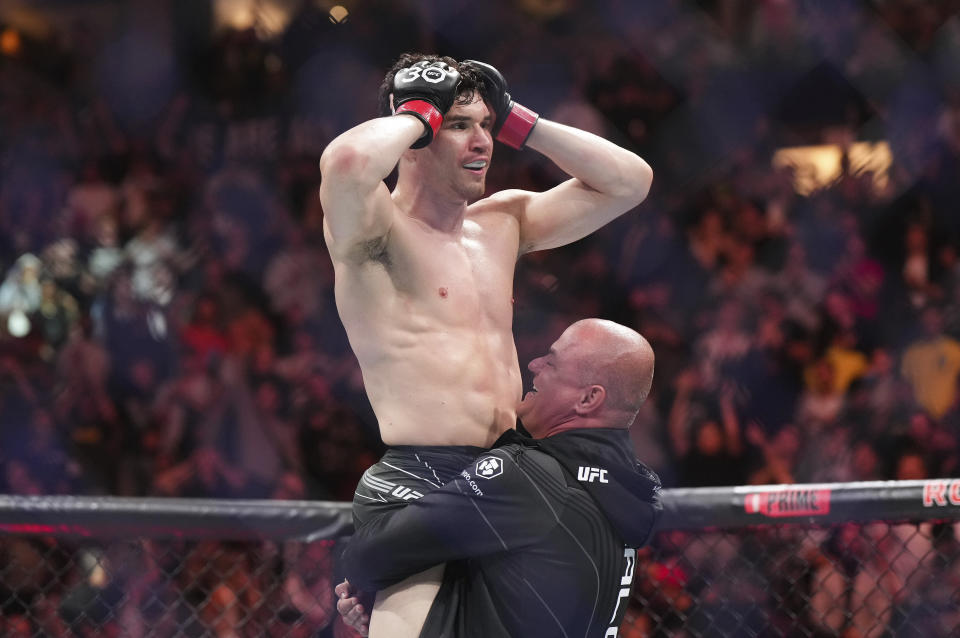 Mike Malott reacts after defeating Adam Fugitt by submission during a welterweight bout at UFC 289 in Vancouver, British Columbia on Saturday, June 10, 2023. (Darryl Dyck/The Canadian Press via AP)