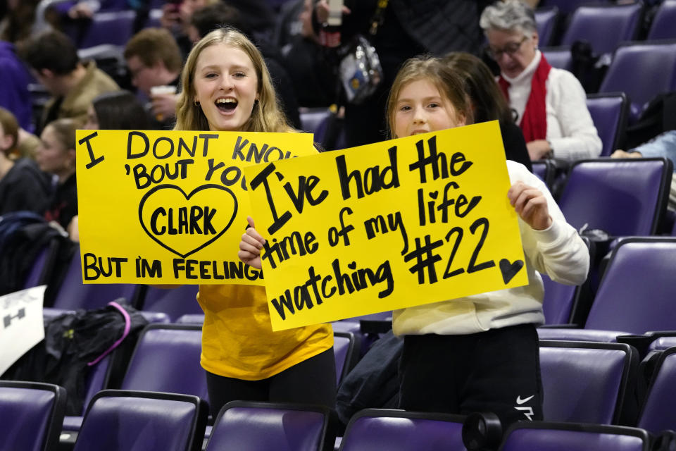 Supporters hold signs for Iowa guard Caitlin Clark before an NCAA college basketball game between Iowa and Northwestern in Evanston, Ill., Wednesday, Jan. 31, 2024. (AP Photo/Nam Y. Huh)