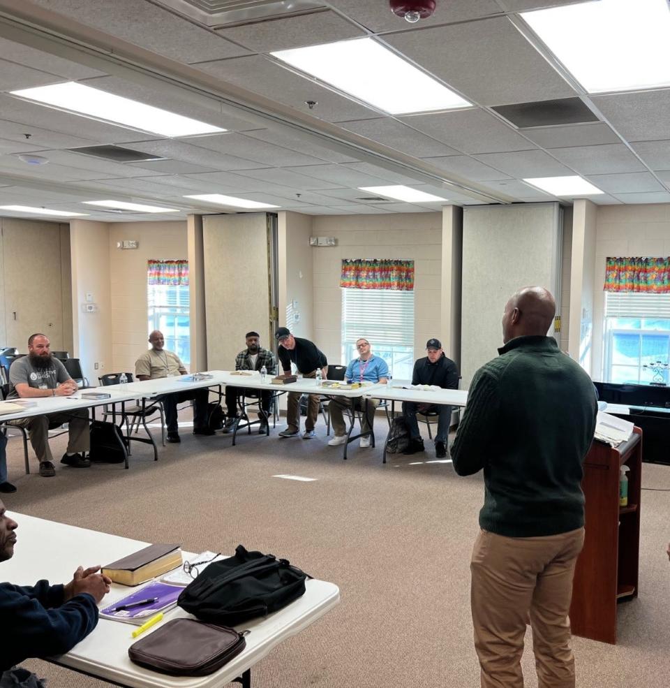 In this file photo, Gov.-Elect Wes Moore, at right, speaks to the men in the Changed Life Recovery Program at the Frederick Rescue Mission in Frederick, Maryland on Jan. 16, 2023. The mission was Moore's first stop on the Martin Luther King Jr. National Day of Service.