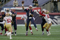New England Patriots quarterback Cam Newton, center, passes under pressure from San Francisco 49ers linebacker Azeez Al-Shaair (51) and defensive end Dion Jordan, right, in the first half of an NFL football game, Sunday, Oct. 25, 2020, in Foxborough, Mass. (AP Photo/Charles Krupa)