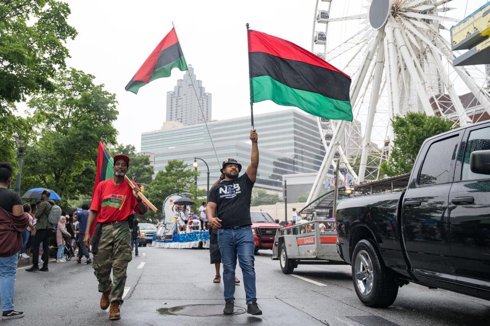 People participate in a parade to celebrate Juneteenth on June 19, 2021, in Atlanta, Georgia. Juneteenth marks the end of slavery in the United States and the Juneteenth National Independence Day became the 12th legal federal holiday signed on June 17th, 2021.