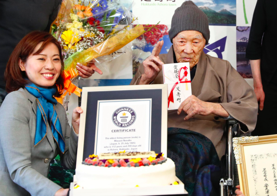 <em>The 112-year-old celebrated his record by tucking in to some cake (PA)</em>