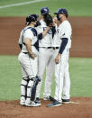 Tampa Bay Rays catcher Mike Zunino, left, and starter Rtyan Yarbrough, center, talks with pitching coach Kyle Snyder on the mound during the sixth inning of a baseball game Wednesday, Aug. 5, 2020, in St. Petersburg, Fla. (AP Photo/Steve Nesius)