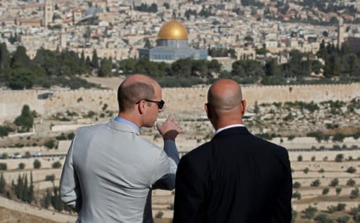 Britain's Prince William talks with a guide as he surveys Jerusalem's flashpoint Al-Mosque mosque compound and its golden-topped Dome of the Rock on June 28, 2018