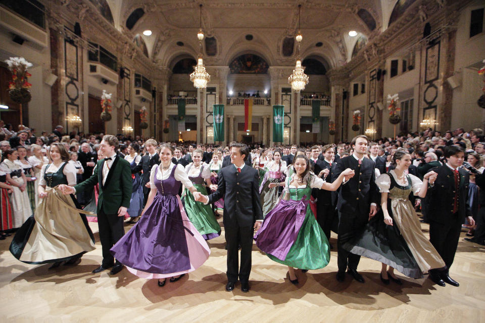 Men and women dance in traditional costumes at the Hunters' Ball in Vienna