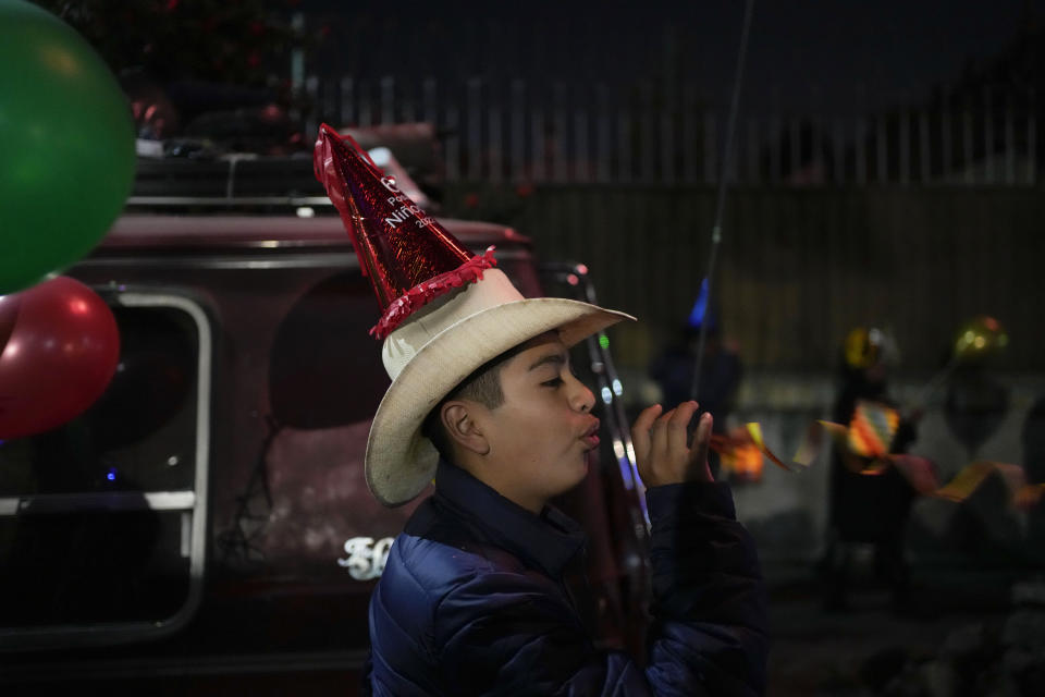 A man participate in the procession of "Ninopan" during a Christmas "posada," which means lodging or shelter, in the Xochimilco borough of Mexico City, Wednesday, Dec. 21, 2022. For the past 400 years, residents have held posadas between Dec. 16 and 24, when they take statues of baby Jesus in procession to church for Mass to commemorate Mary and Joseph's cold and difficult journey from Nazareth to Bethlehem in search of shelter. (AP Photo/Eduardo Verdugo)