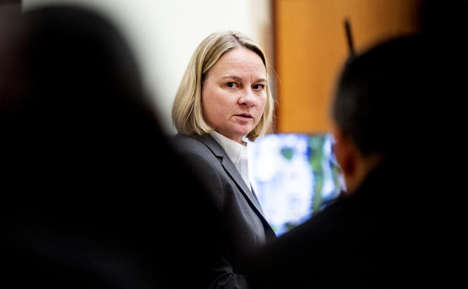 Washington State assistant attorney Lori Nicolavo looks back at other prosecutors during the trial of Tacoma Police Officers Christopher Burbank, Matthew Collins and Timothy Rankine in the killing of Manny Ellis at Pierce County Superior Court, Tuesday, Oct. 10, 2023, in Tacoma, Wash. (Brian Hayes/The News Tribune via AP, Pool)