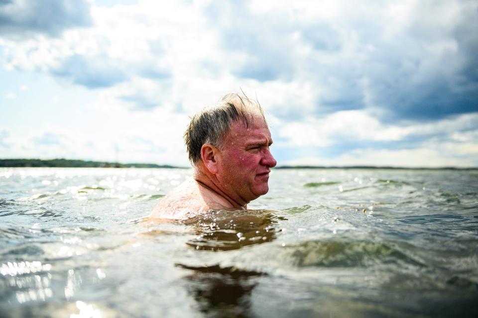 Dan Meehan, a Navy Reserve veteran, swims at the Fourth Cliff Family Recreation Area in Massachusetts in August. He is one of thousands of veterans ensnared by what authorities are calling a nationwide Ponzi scheme.