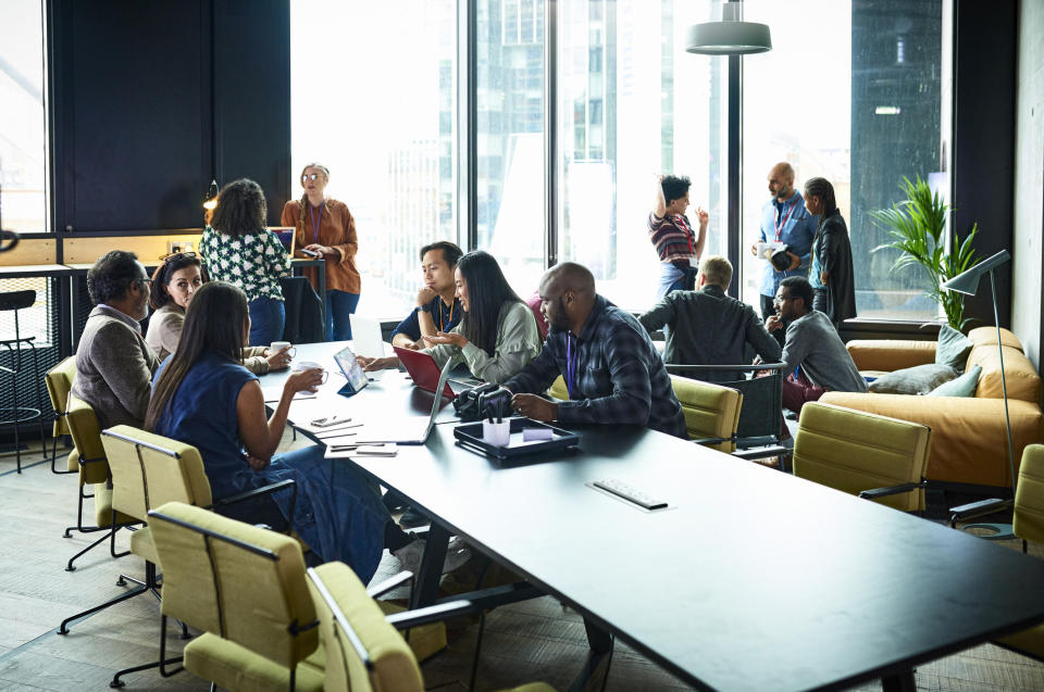 Business people having meeting in conference room. (Getty)