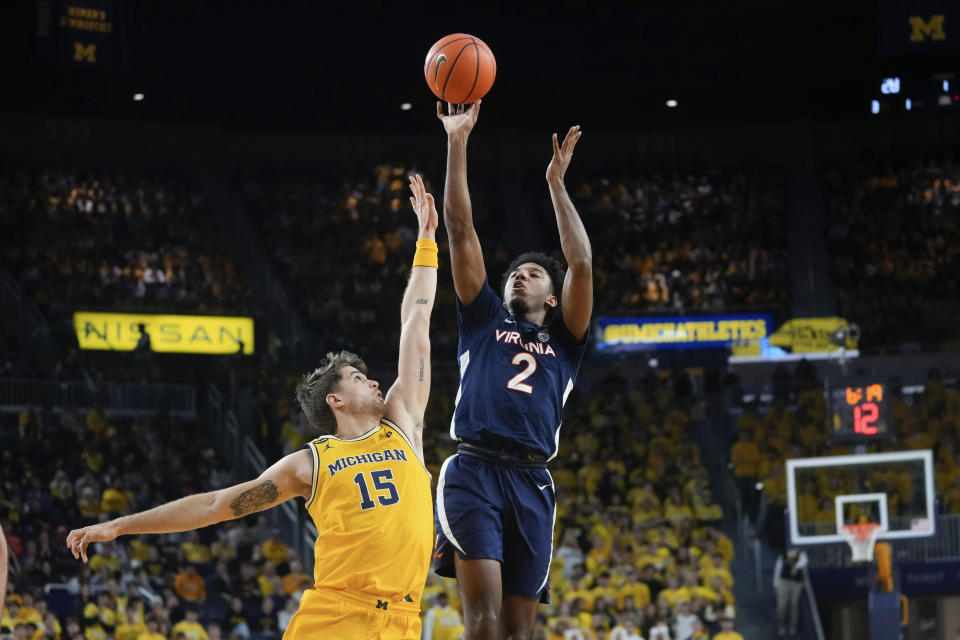 Virginia guard Reece Beekman (2) shoots over Michigan guard Joey Baker (15) in the first half of an NCAA college basketball game in Ann Arbor, Mich., Tuesday, Nov. 29, 2022. (AP Photo/Paul Sancya)