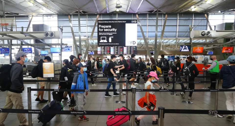 A photo of travellers in Sydney Aiport.