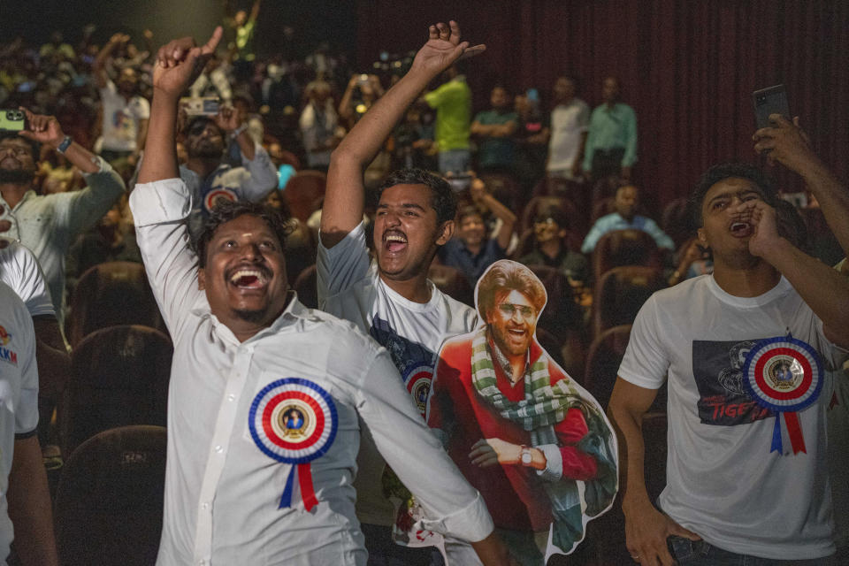 Fans of Indian superstar Rajinikanth, cheer at a cinema hall as they celebrate the screening of his latest film "Jailer" in Mumbai, India, Thursday, Aug. 10, 2023. (AP Photo/Rafiq Maqbool)