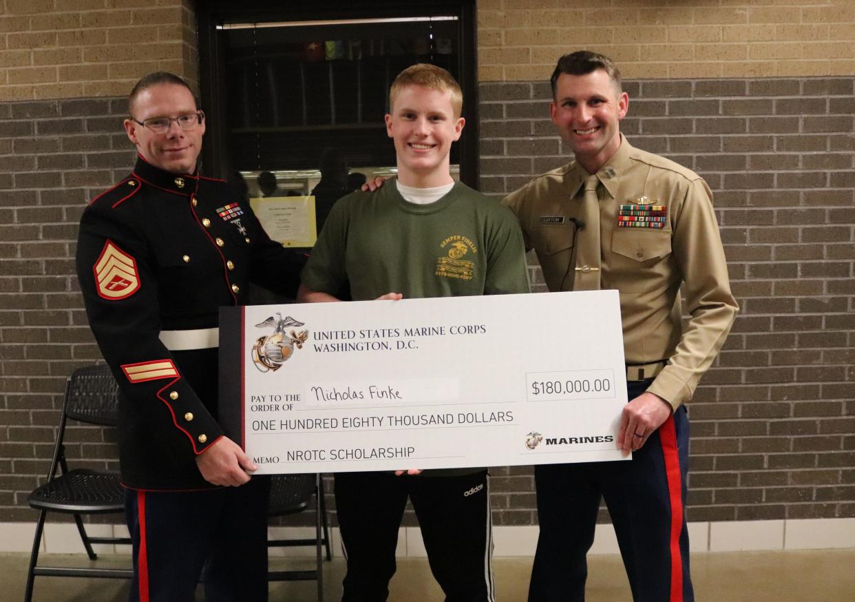 Nick Finke, a senior at Kickapoo High School, was awarded the scholarship during a Dec. 14 visit from Capt. Jacob Layton, executive officer for the U.S. Marine Corps recruiting station in Kansas City. His father, U.S. Navy veteran Bryan Finke, was also there.