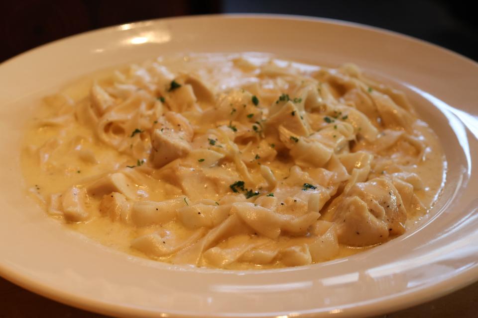 A dish of Alfredo sauce and pasta in bowl at The Cheesecake Factory