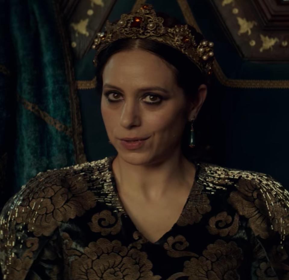 Jodhi May as Queen Calanthe speaks to Geralt while seated at a banquet feast in "The Witcher"
