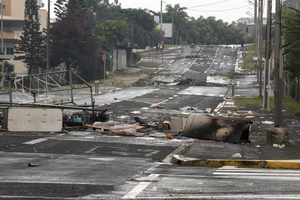 A street in Noumea, New Caledonia, is pictured after unrest, Wednesday May 15, 2024. France has imposed a state of emergency in the French Pacific territory of New Caledonia. The measures imposed on Wednesday for at least 12 days boost security forces' powers to quell deadly unrest that has left four people dead, erupting after protests over voting reforms. (AP Photo/Nicolas Job)