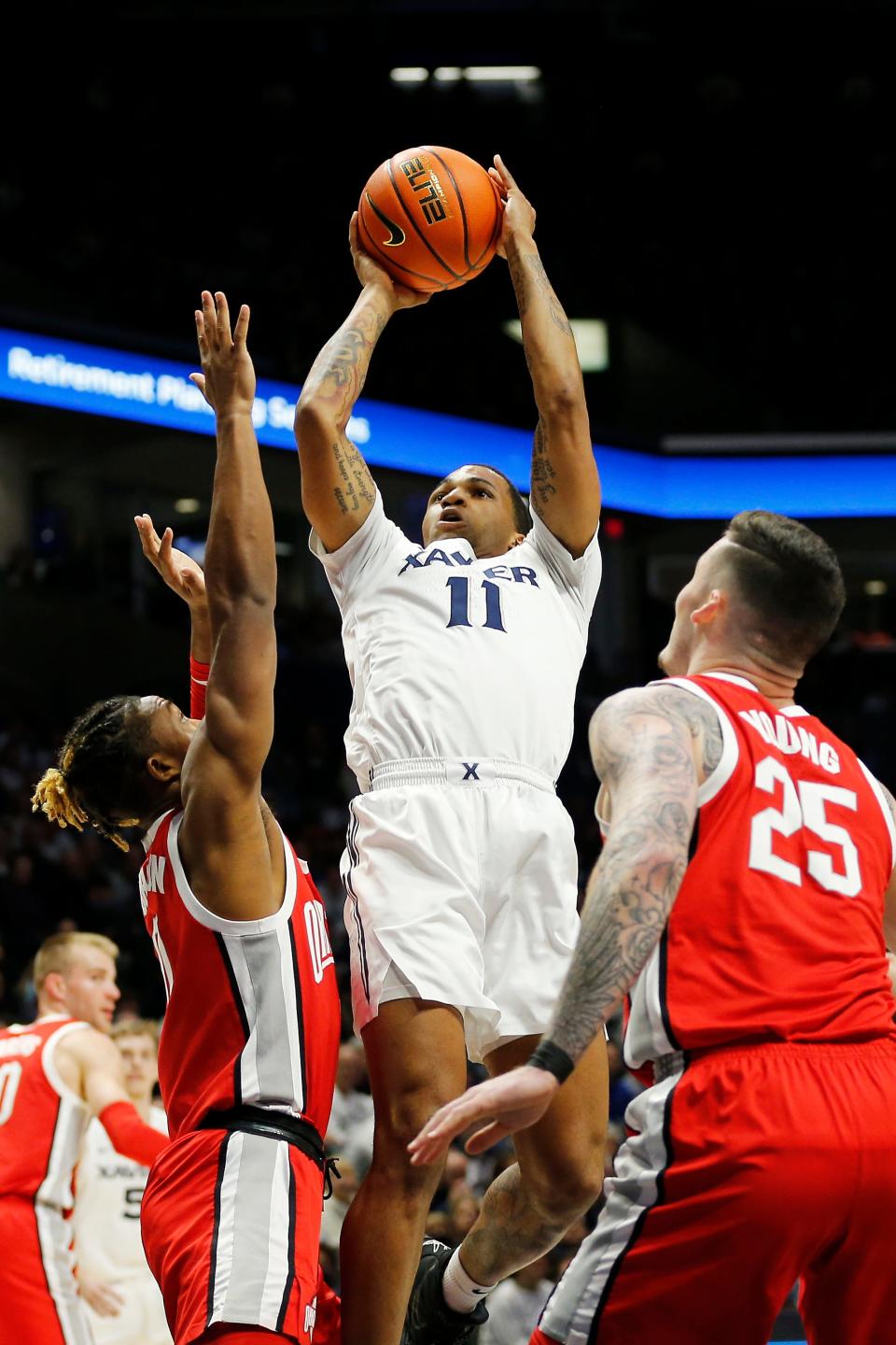 Xavier Musketeers guard Dwon Odom (11) rises to shoot in the first half of the NCAA basketball game between the Xavier Musketeers and the Ohio State Buckeyes at the Cintas Center in Cincinnati on Thursday, Nov. 18, 2021.