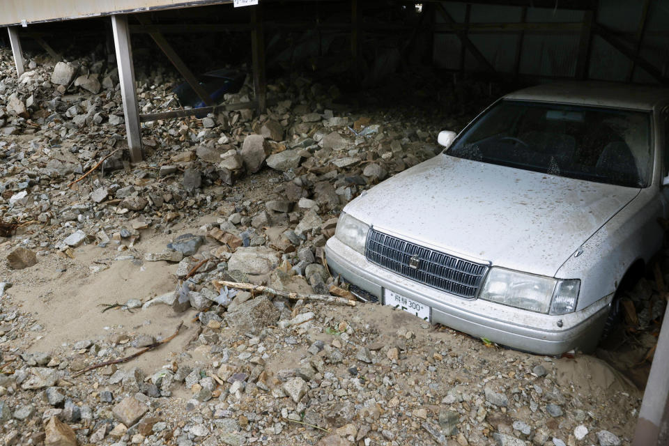 A parking lot is filled with earth and sand following a heavy rain in Gero, Giru prefecture, central Japan Thursday, July 9, 2020. Pounding rain spread to central Japan and triggered mudslides. (Kyodo News via AP)