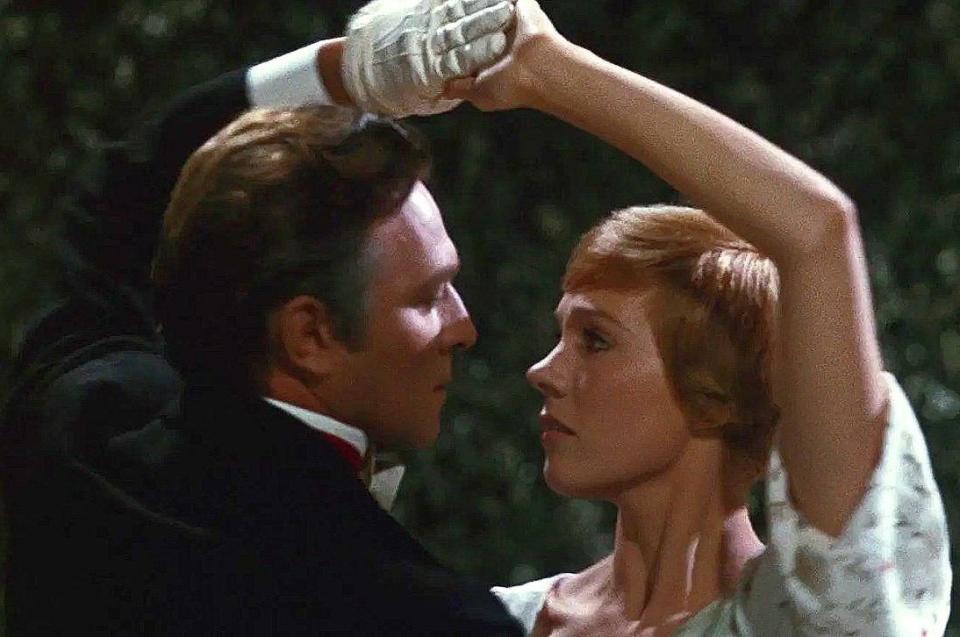 Captain von Trapp and Maria staring into each other's eyes