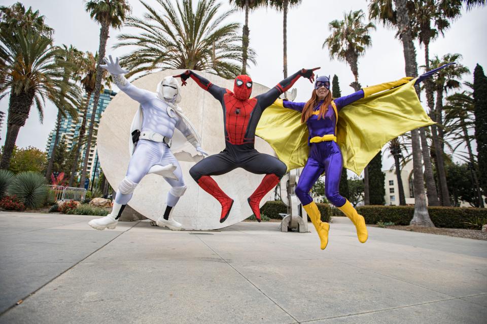 Cosplayers dressed as Moon Knight, Spider-Man, and Batgirl at San Diego Comic-Con 2022.