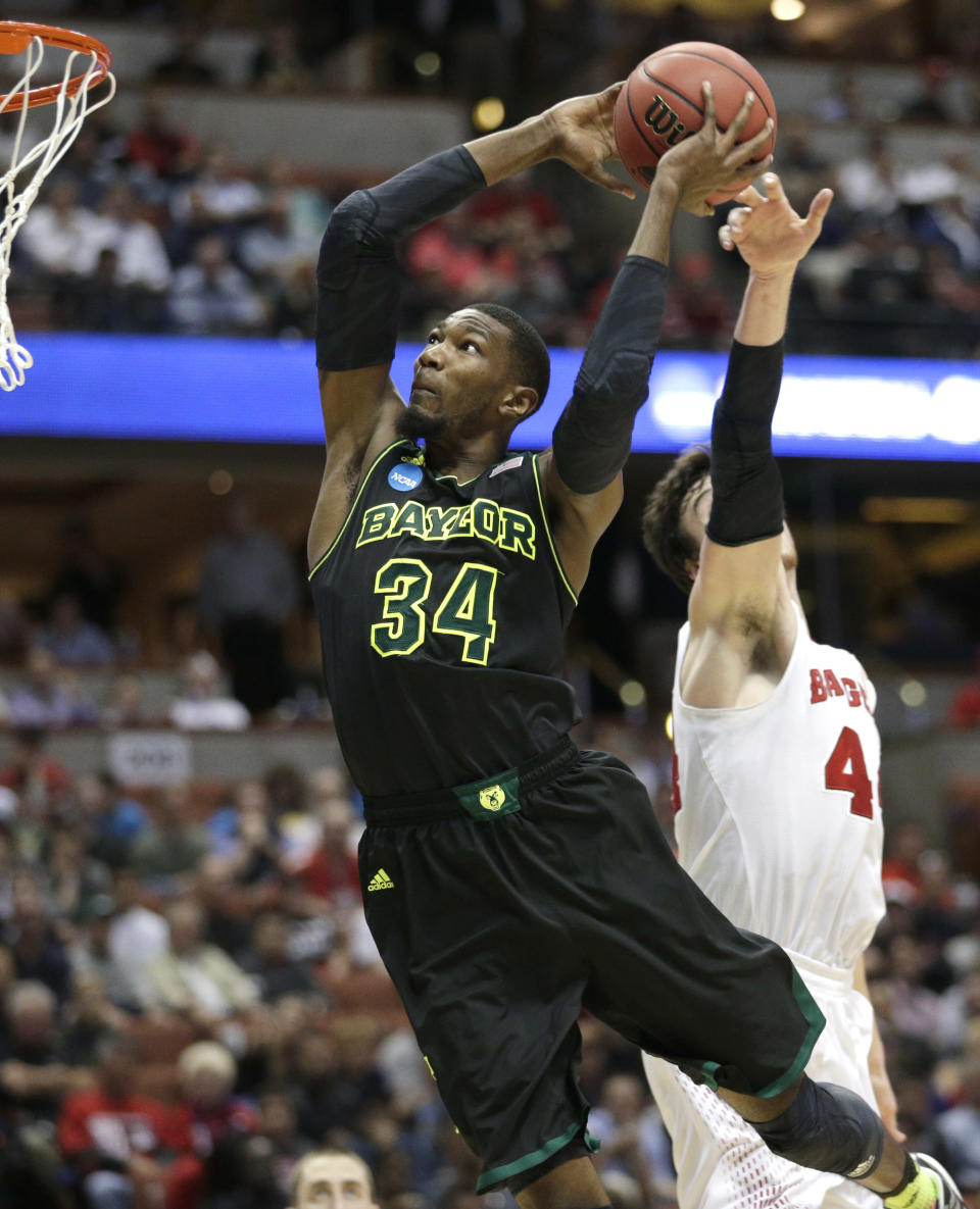 Wisconsin forward Frank Kaminsky right, can't stop Baylor forward Cory Jefferson (34) from dunking during the second half of an NCAA men's college basketball tournament regional semifinal, Thursday, March 27, 2014, in Anaheim, Calif. (AP Photo/Jae C. Hong)